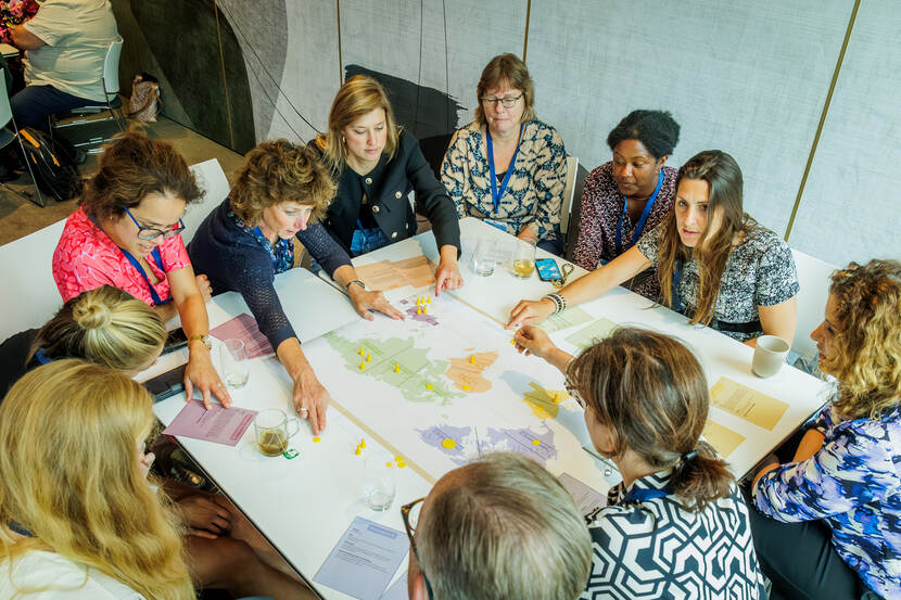 Groepje vrouwen leggen arm op tafel